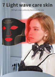 Woman using an LED face mask for an at-home facial care routine